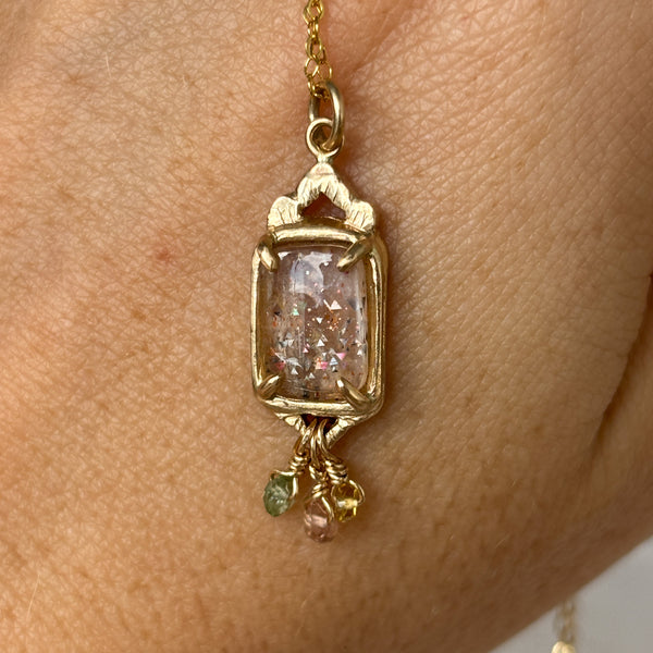 Myth and Stone Temple of Joy rainbow lattice sunstone pendant on hand