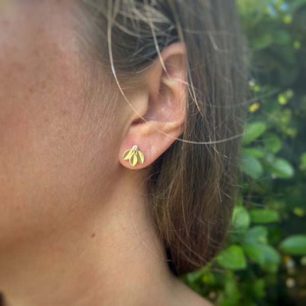 Myth and Stone Trilogy diamond studs on model
