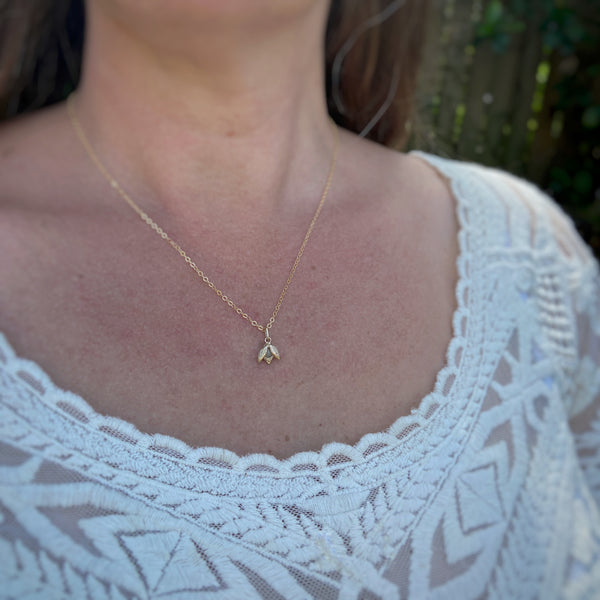 Myth and Stone Alida opal bug charm on model