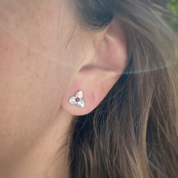 Myth and Stone Trillium studs in silver with garnet on model