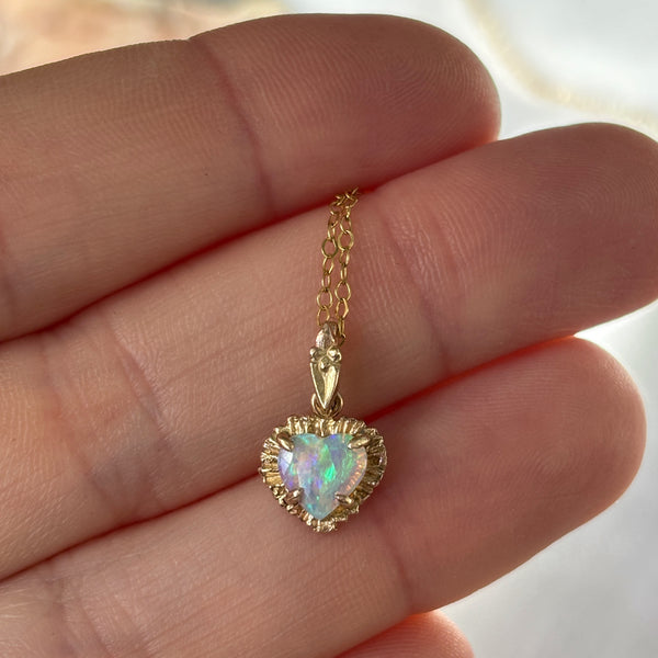 Myth and Stone Illuminated Heart opal charm on hand