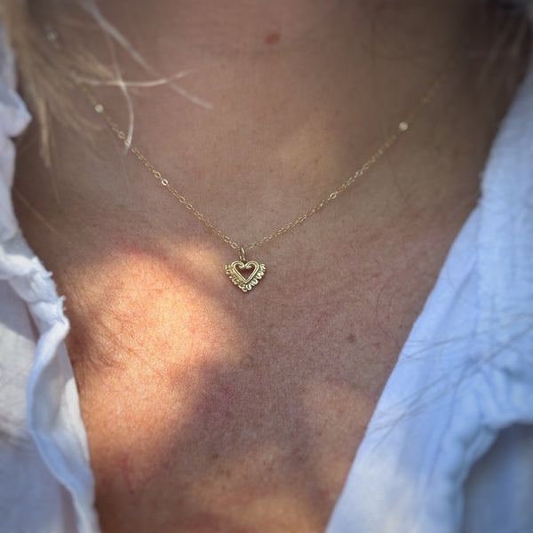 Myth and Stone Heart in Bloom charm on neck