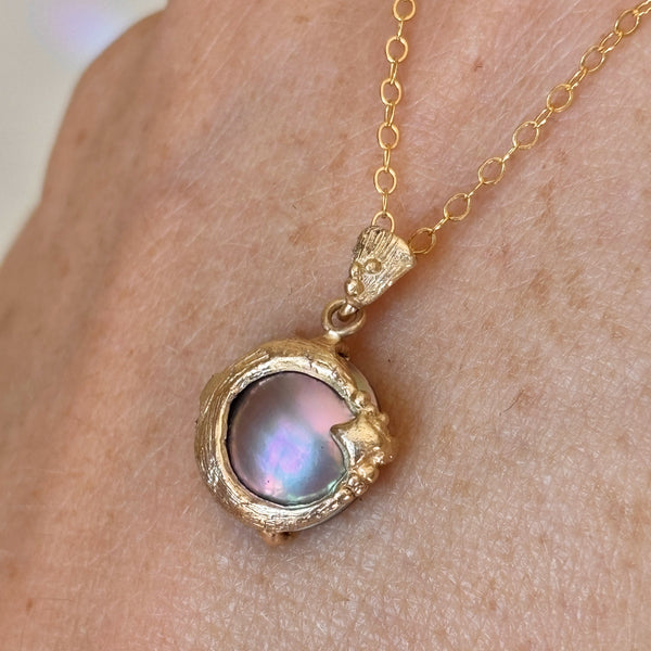 Myth and Stone moon's Daughter gold and pearl pendant on hand