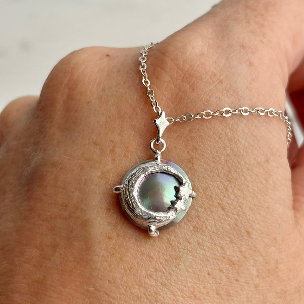 Myth and Stone Moon's Daughter pearl pendant in silver on hand