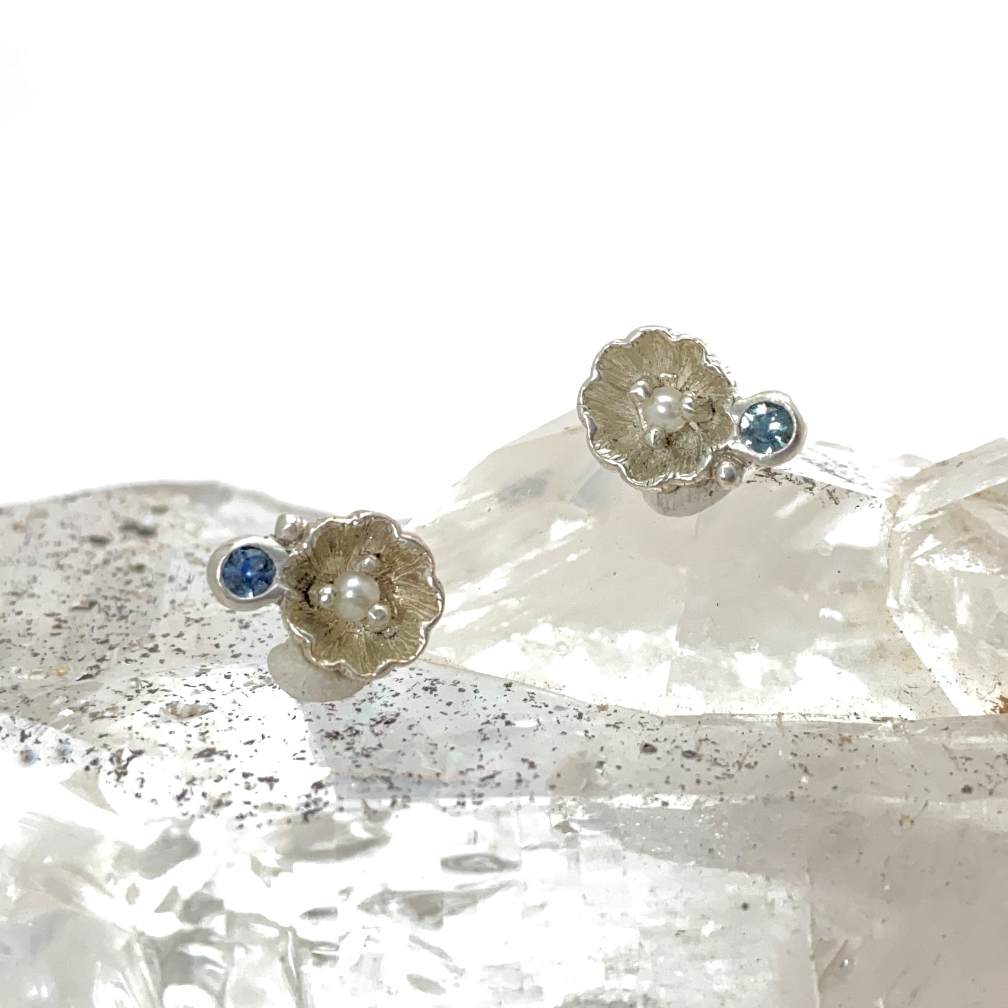 Myth and Stone blossom studs with pearl and sapphire front view