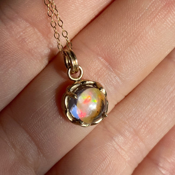 Myth and Stone Inner Light opal pendant on hand