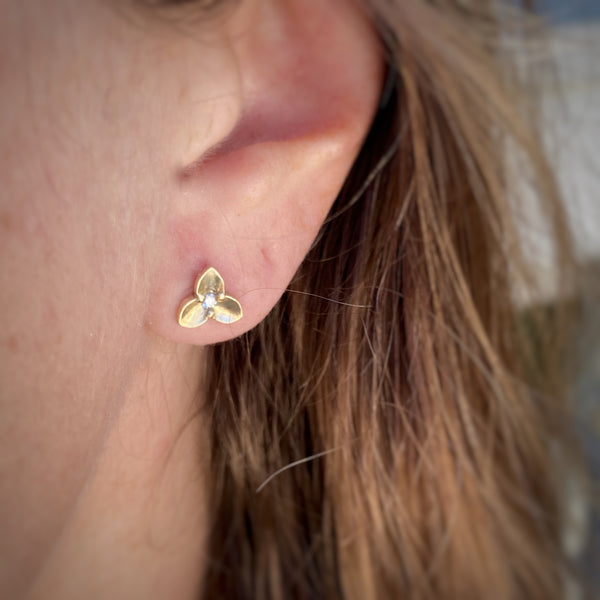 Myth and Stone Trillium studs in gold on model
