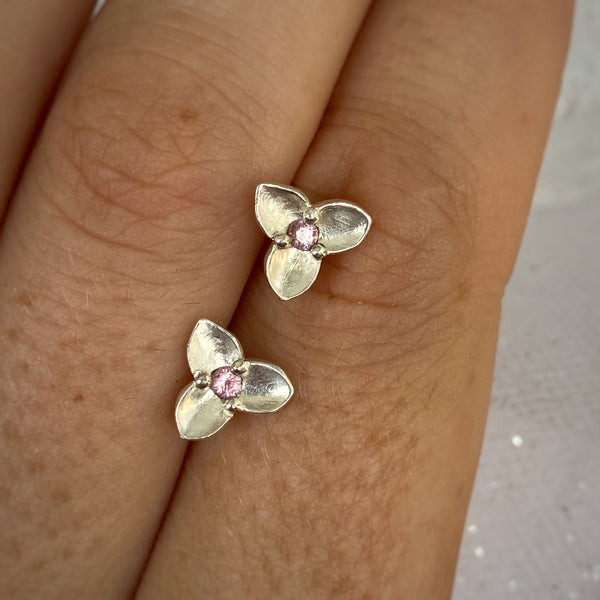 Myth and Stone Trillium studs in silver with pink spinel on hand